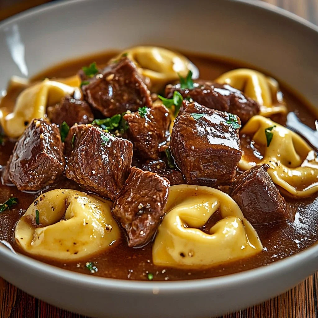 Cracked Garlic Steak Tortellini served in a bowl with herbs and parmesan.